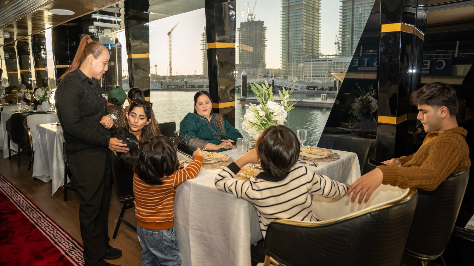 Family dining beside Dubai Marina